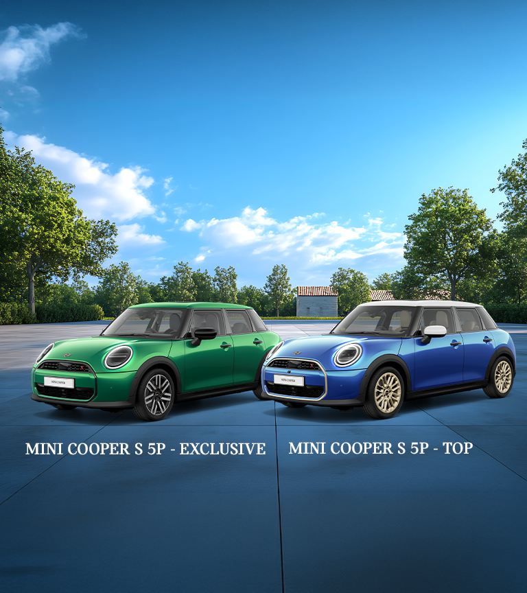 A silver MINI Cooper 5-Door drives swiftly down a city street, passing a bright blue wall and brick building. The scene conveys a sense of speed and urban energy.